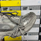Balenciaga unisex gray sneaker side view with lace-up closure and panel stitching.