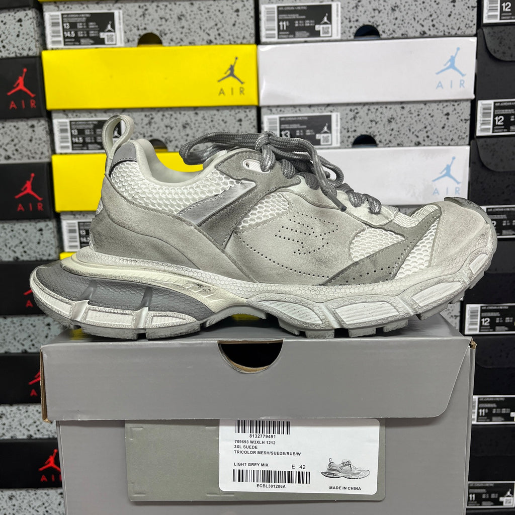 Balenciaga low-top sneaker in light gray with lace-up closure and textured panel details