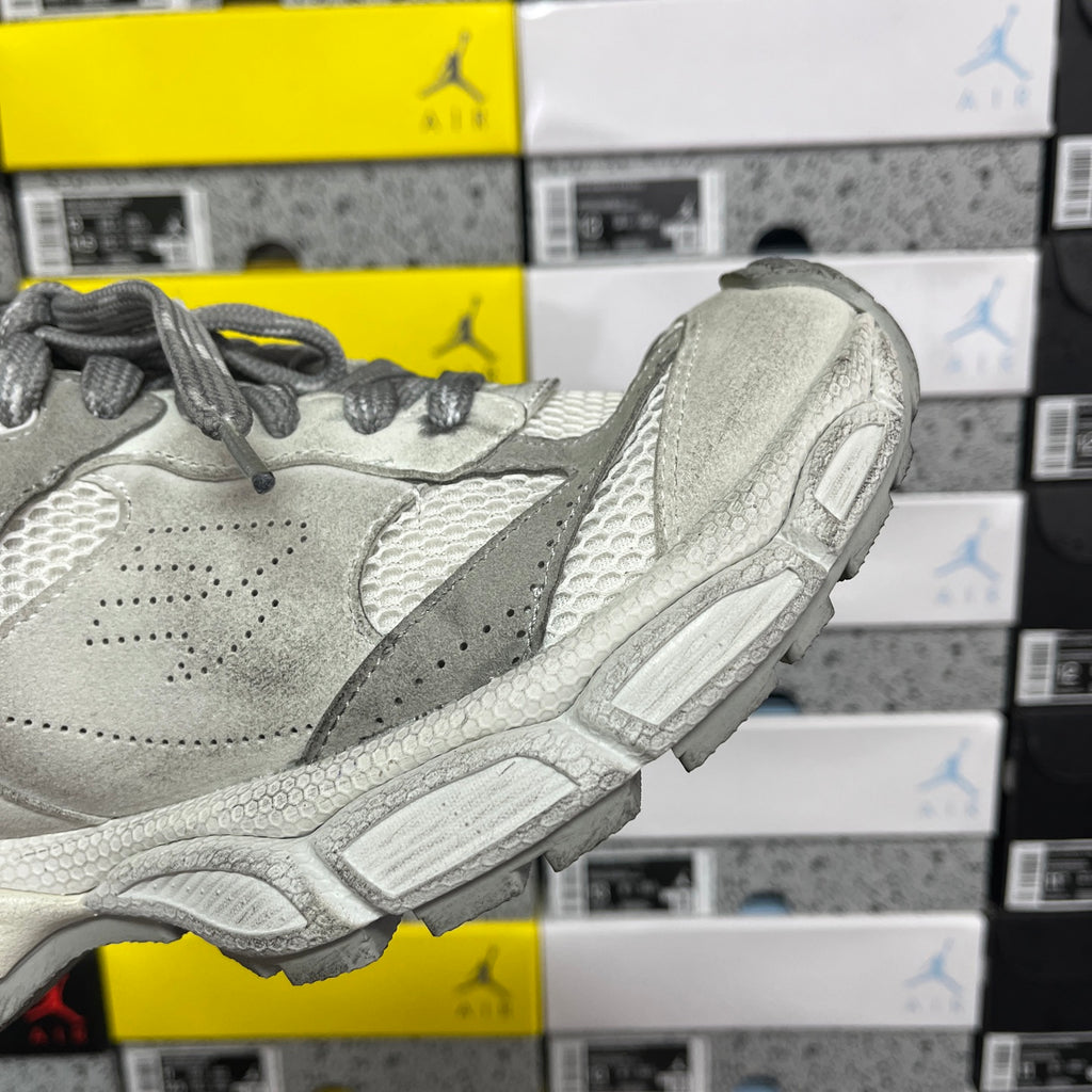 Balenciaga sneaker side profile in light gray with suede overlays, mesh sections, and laces