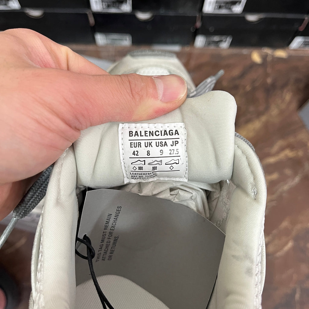 Balenciaga size label inside a light gray sneaker, marked EUR/US/JP and size numbers