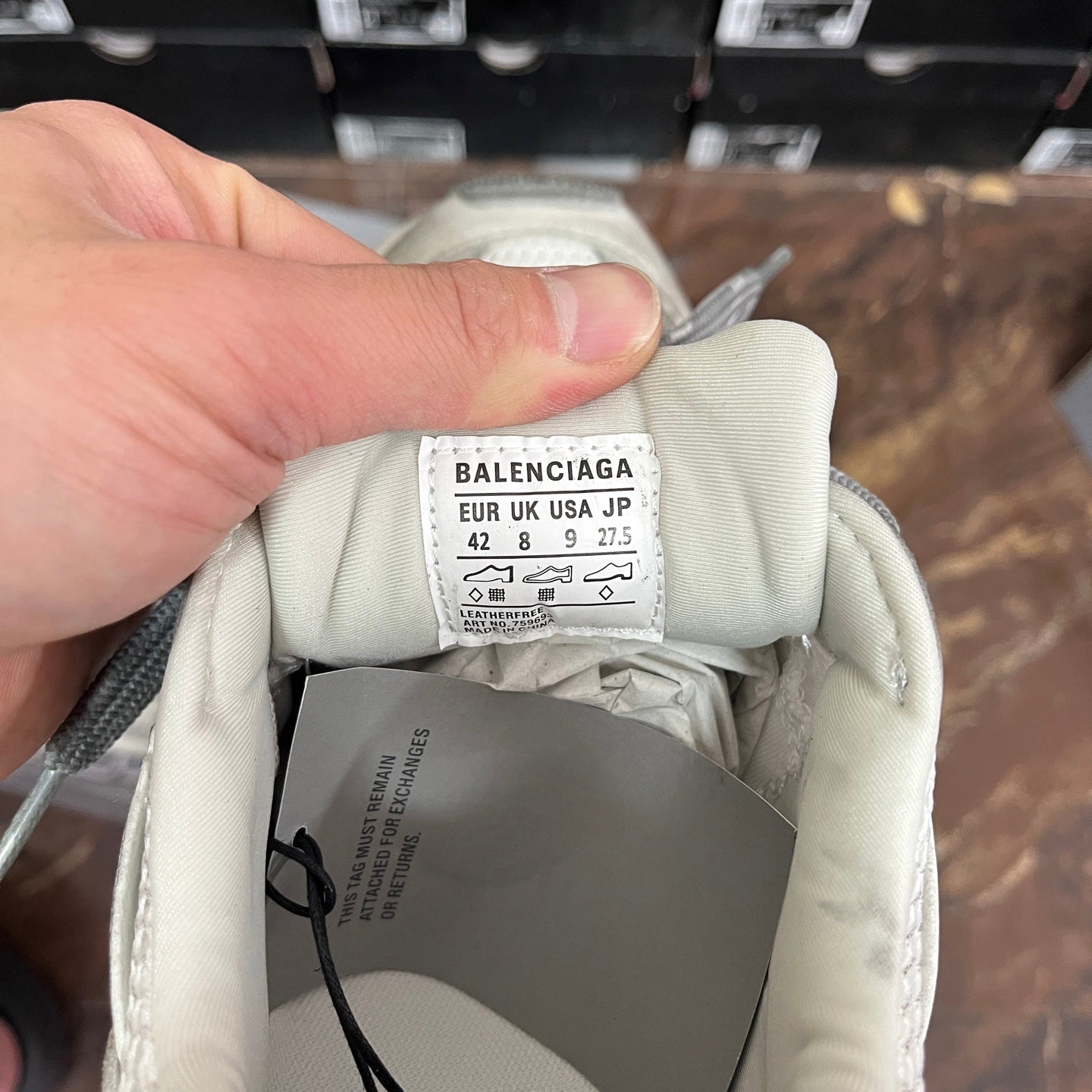 Balenciaga size label inside a light gray sneaker, marked EUR/US/JP and size numbers
