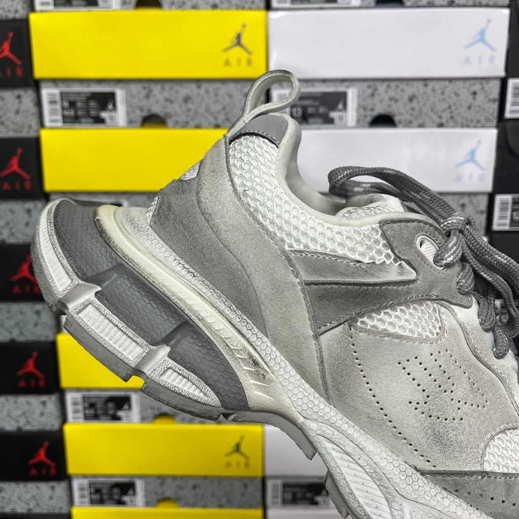 Balenciaga sneaker angled side view in light gray with padded collar and chunky midsole