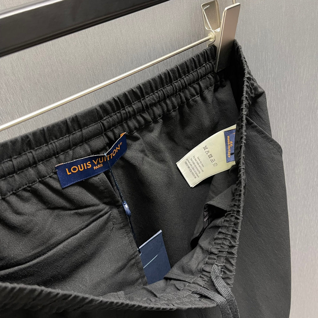 Black shorts with Louis Vuitton hang tag and size label at waistband