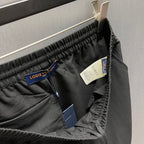 Black shorts with Louis Vuitton hang tag and size label at waistband