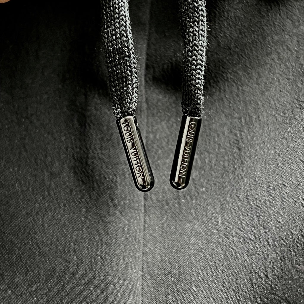 Black shorts with braided drawstrings and metal toggles