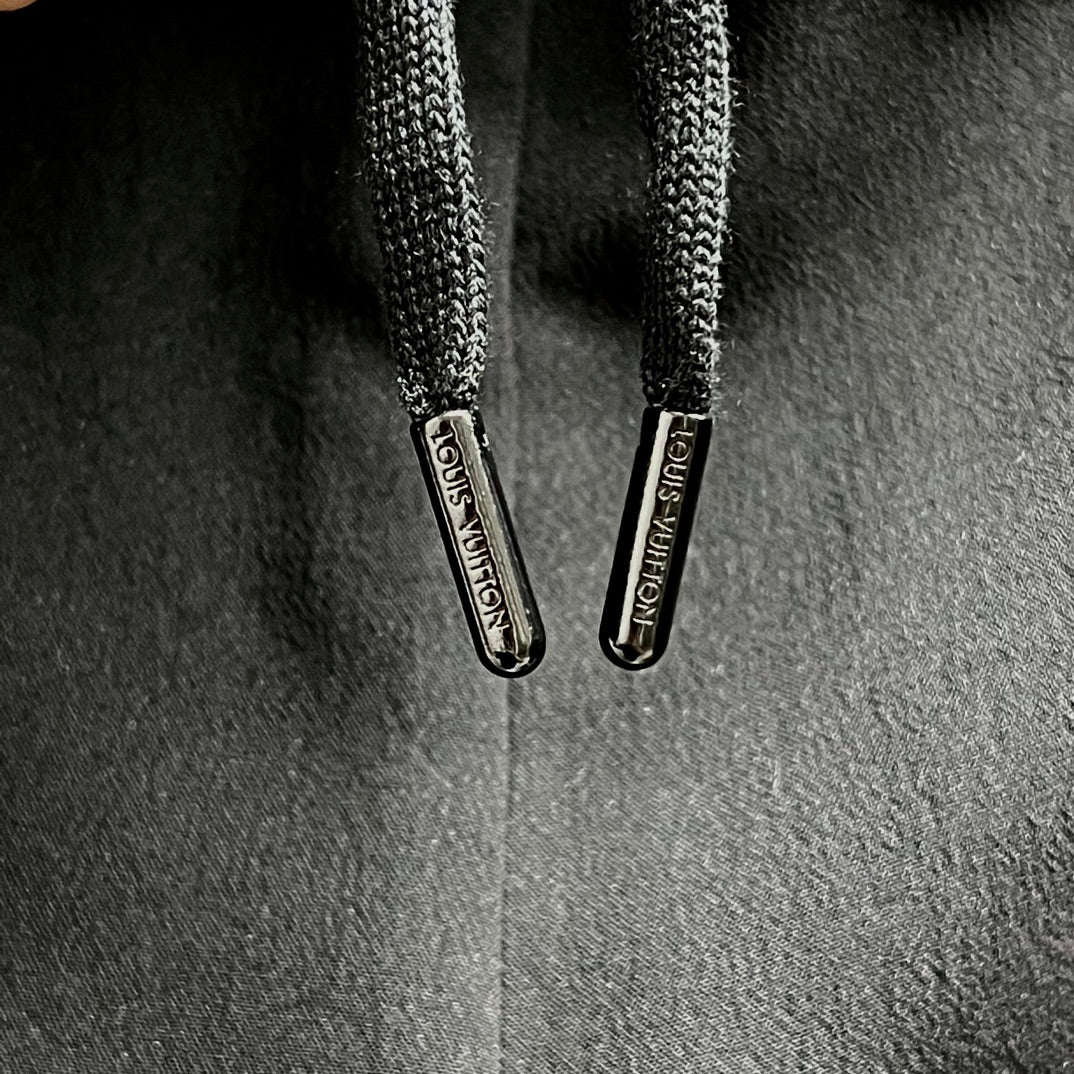 Black shorts with braided drawstrings and metal toggles