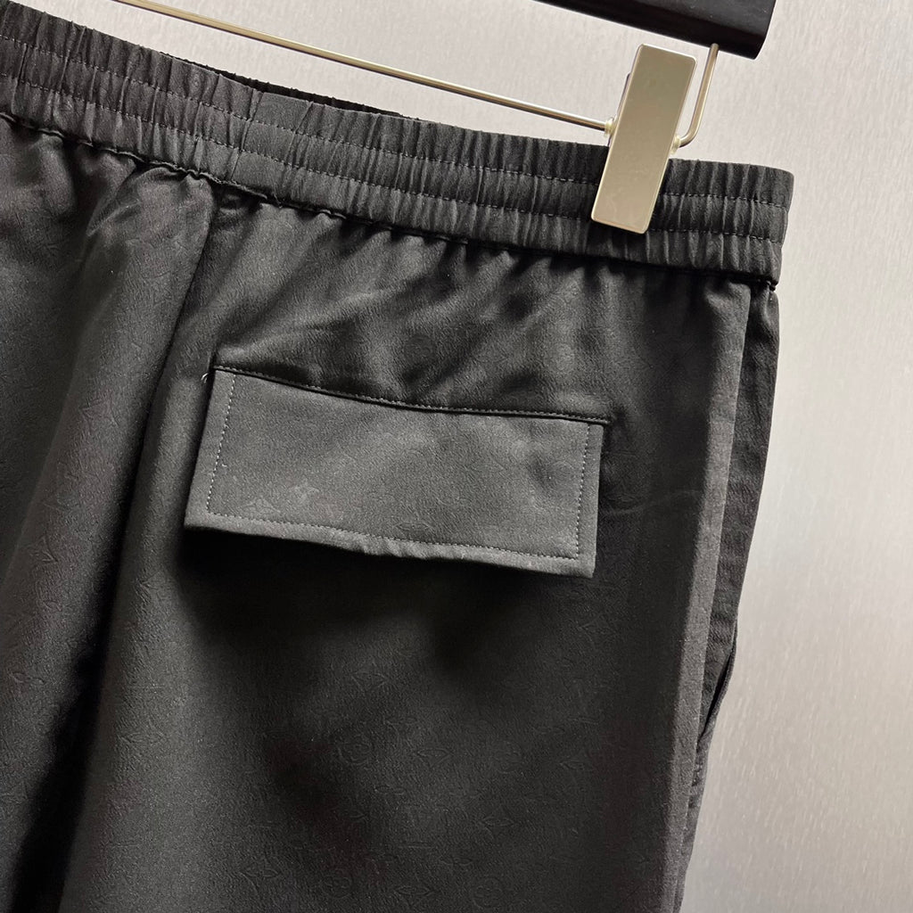 Black shorts with stitched patch pocket on the front