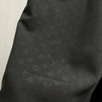 Black shorts fabric close-up with subtle sheen