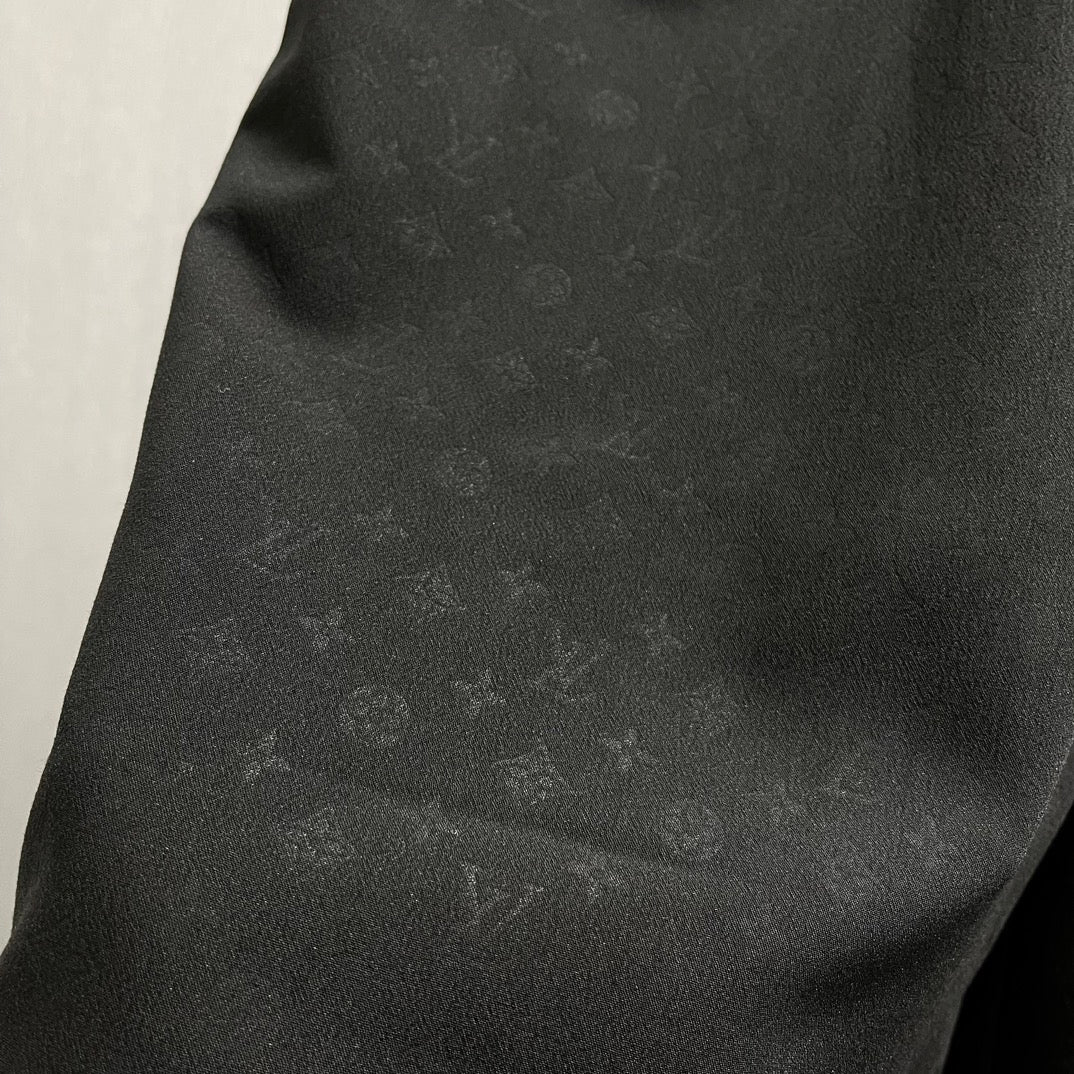 Black shorts fabric close-up with subtle sheen