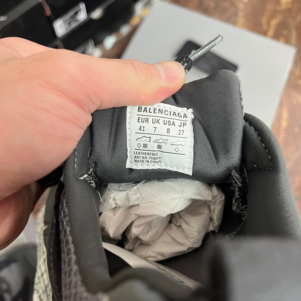 Grey sneaker interior with Balenciaga size label and care tag on fabric lining