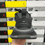 Grey Balenciaga sneaker heel with embossed logo and textured mesh upper