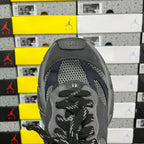 Grey sneaker tongue with lace eyelets and textured mesh upper