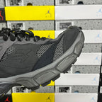 Grey sneaker side profile with perforated paneling and molded rubber heel