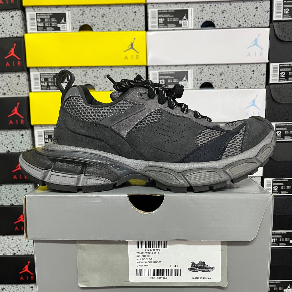 Grey sport sneaker with perforated panels, black laces, and thick tread sole