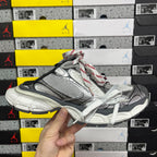Gray and black Balenciaga unisex sneaker with white laces and textured panels