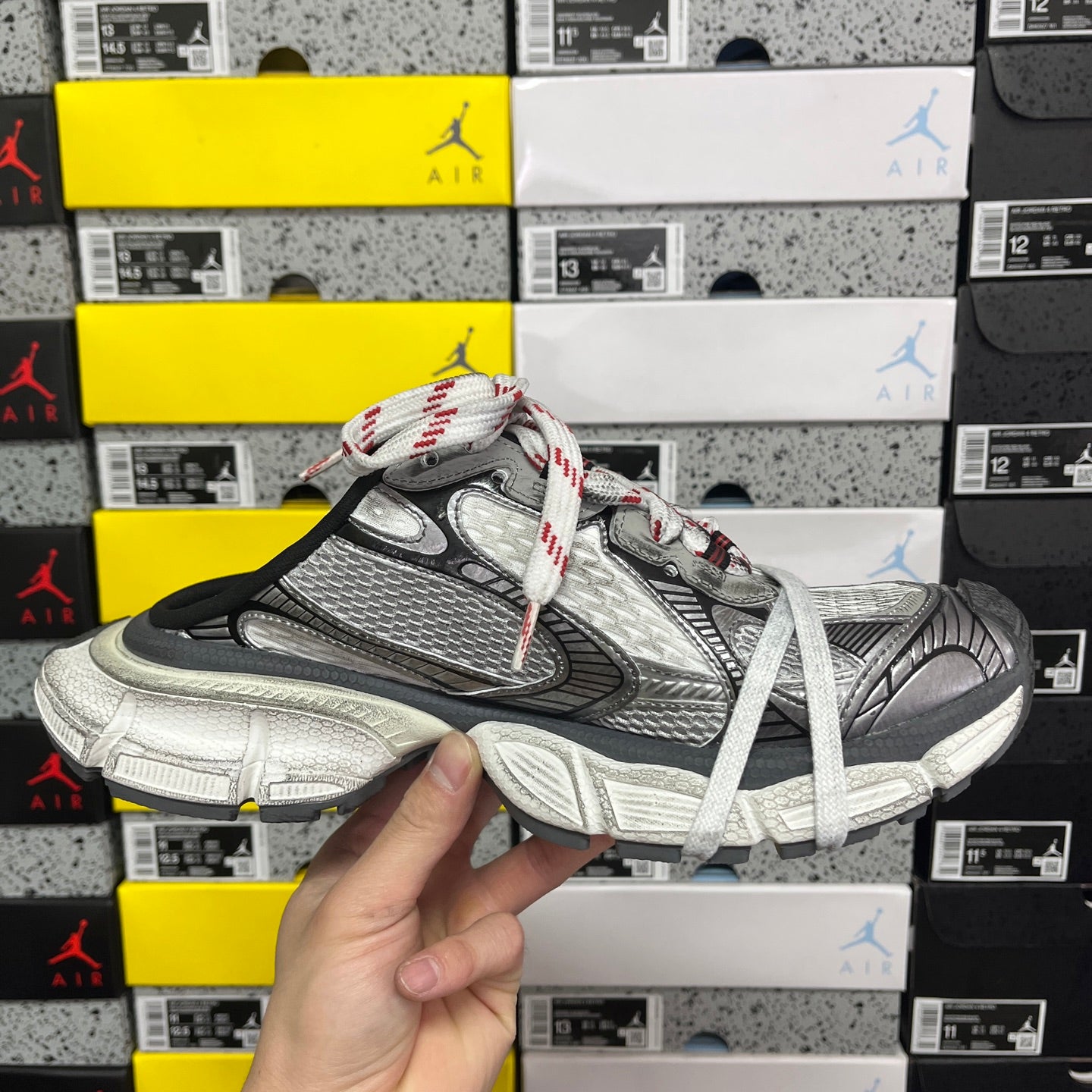 Balenciaga unisex sneaker front view, gray and black panels with white laces