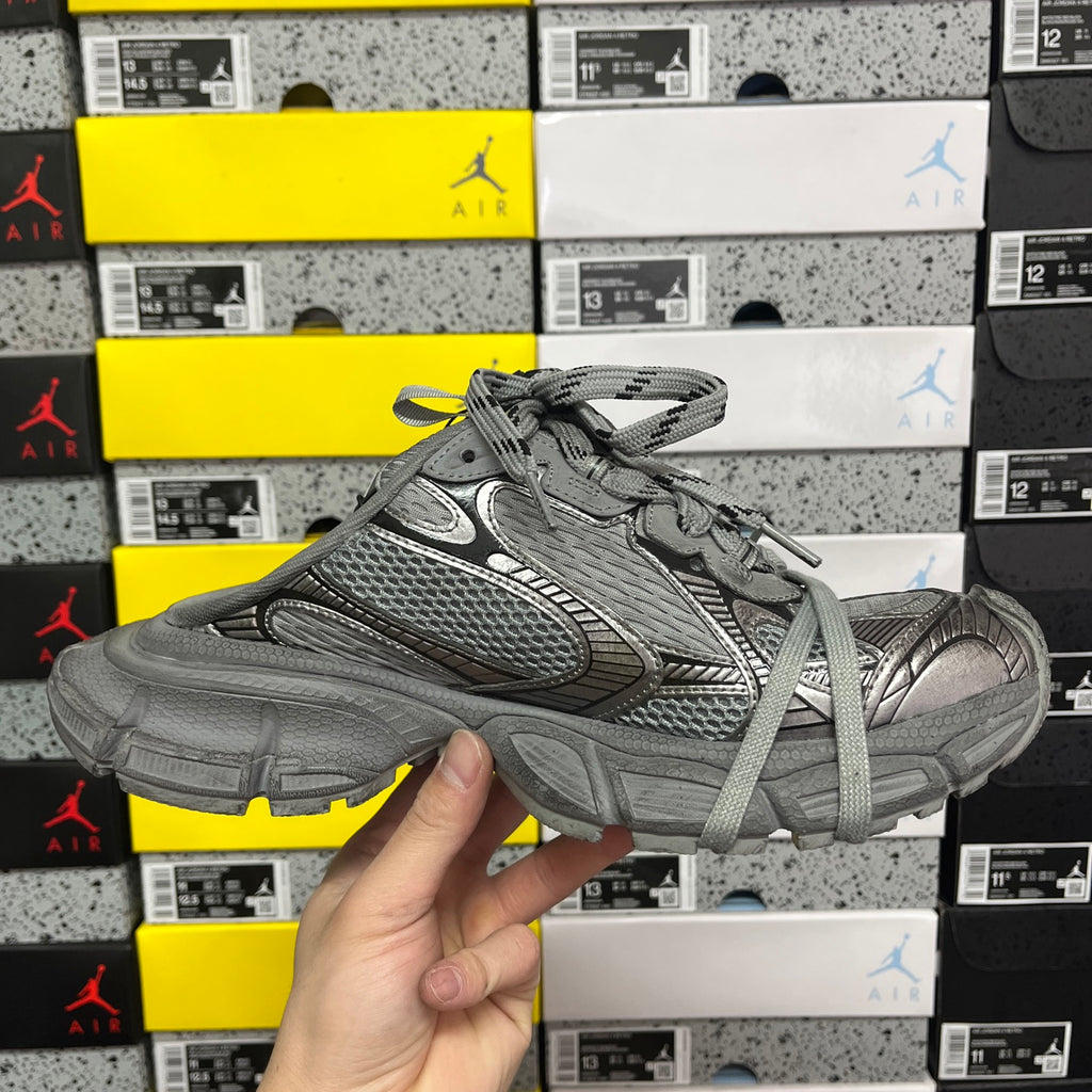 Gray lace-up sneakers showing side profile, mesh upper, and chunky midsole