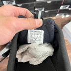 Black sneakers with size label on inner collar and brand text on tag
