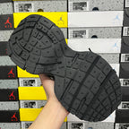Black rubber outsole with tread pattern and traction lugs for athletic use