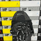 Black sneaker upper with lace-up detail and metallic-looking overlay at toe