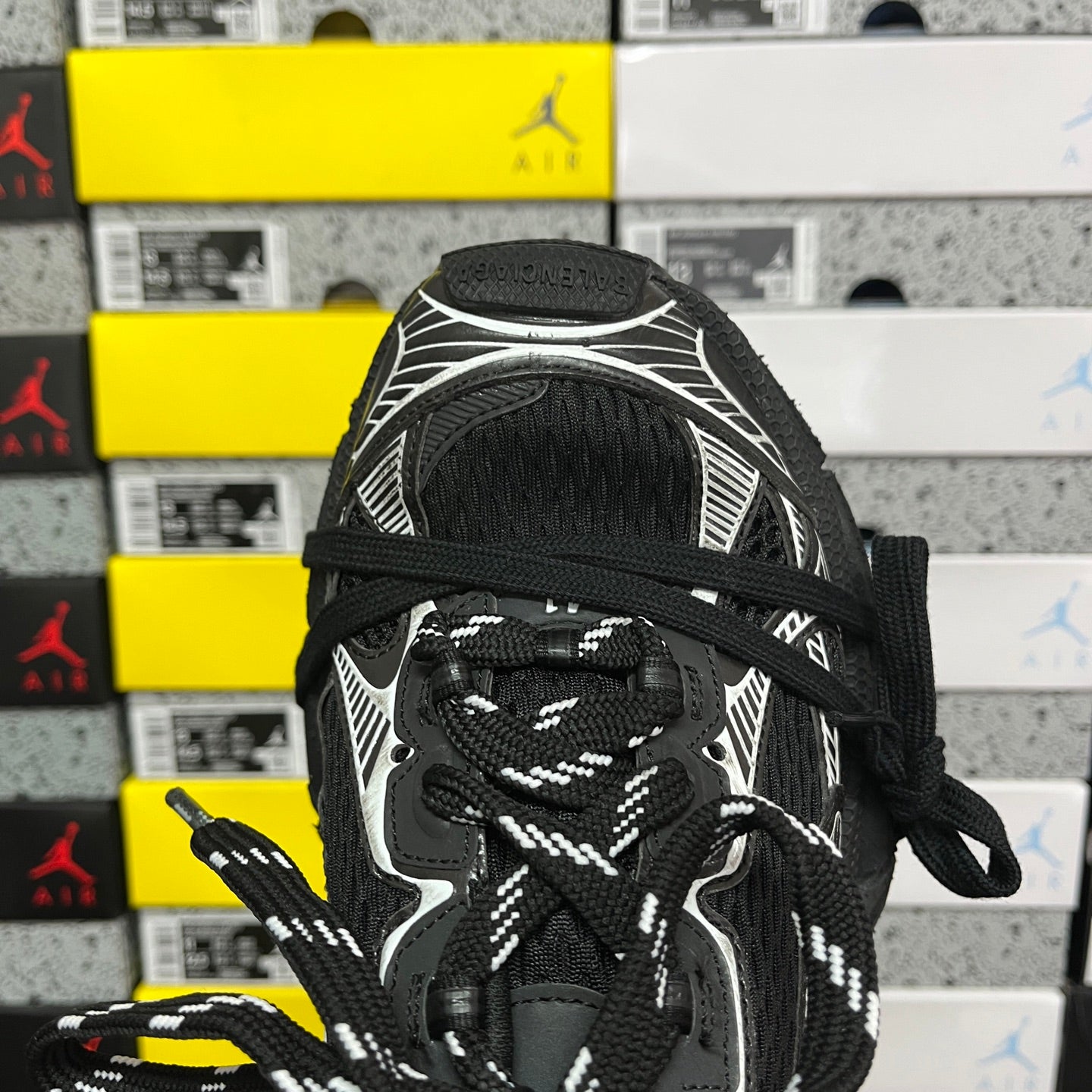 Balenciaga unisex sneakers, close-up of black mesh upper and white patterned panels
