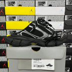 Balenciaga unisex sneakers, black knit upper with white accents, held in front view