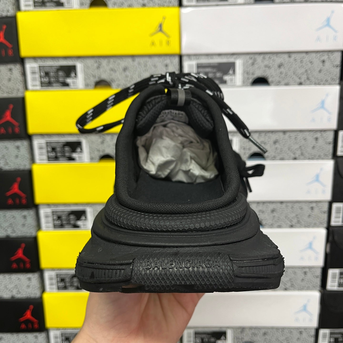 Balenciaga unisex sneakers, heel view with black upper and thick rubber sole