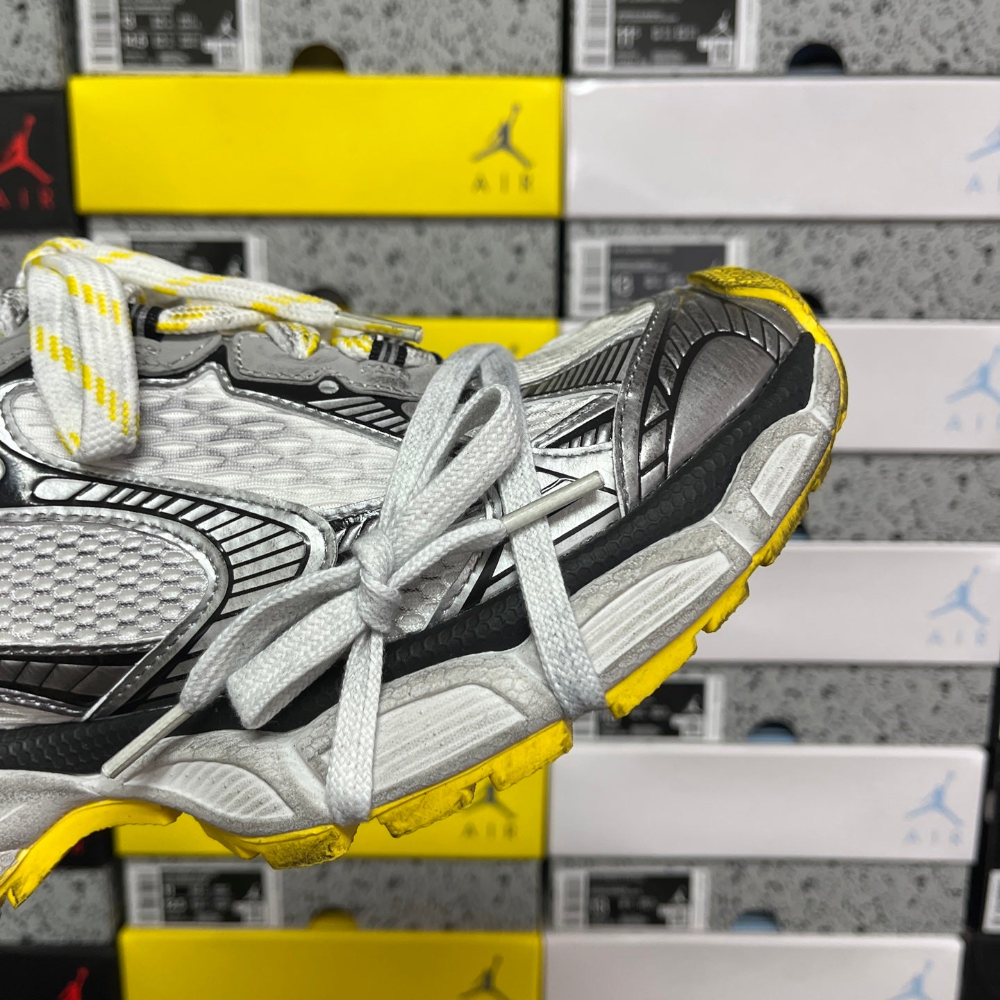 Balenciaga unisex sneakers side detail with silver-gray mesh, black trim, yellow outsole edge