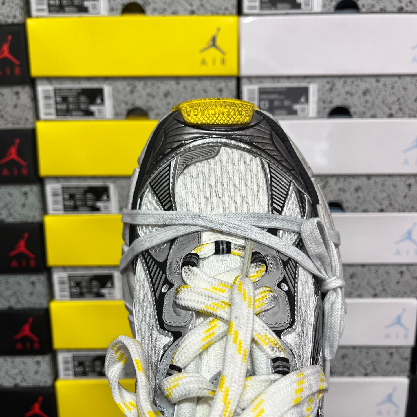 Balenciaga unisex sneakers close-up on tongue and lace area, yellow-lined eyelets