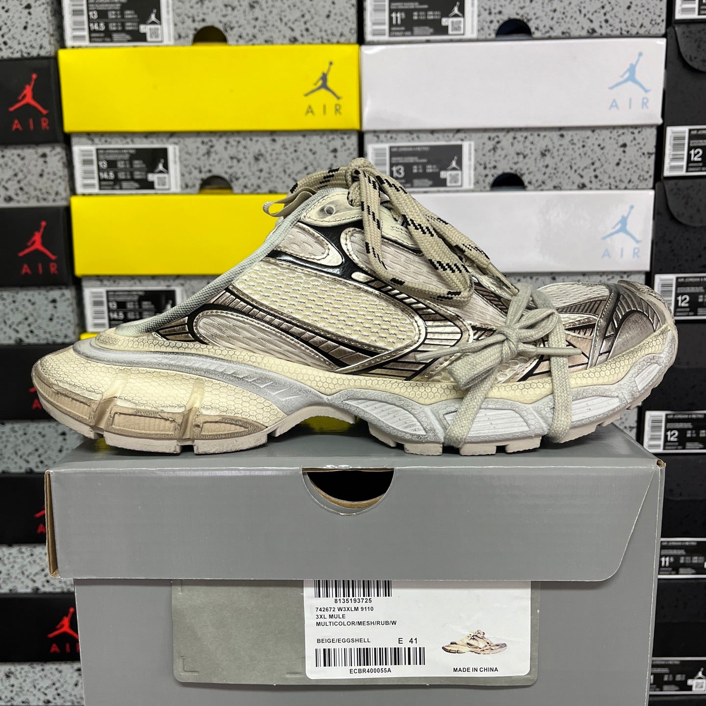 Off-white Balenciaga unisex sneakers on box, side view with lace-up closure