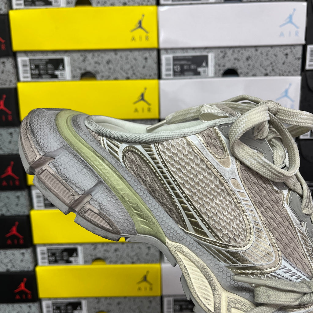 Light gray lace-up sneaker with mesh upper, layered straps, and sage green sole trim.