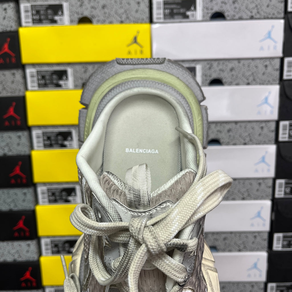 Balenciaga sneaker heel interior with stitched logo label and light gray padded lining.
