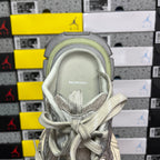 Balenciaga sneaker heel interior with stitched logo label and light gray padded lining.