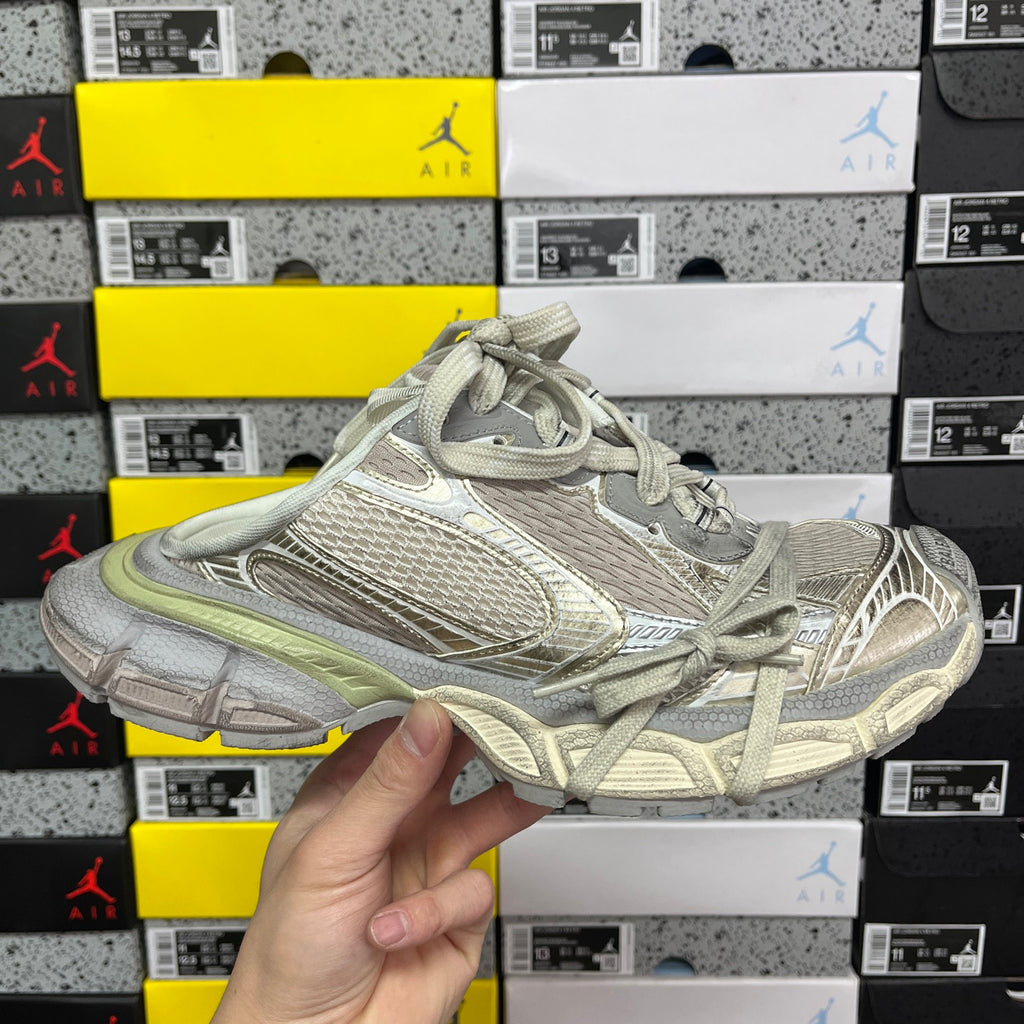 Light gray Balenciaga sneaker with mesh texture and sage green trim, lace-up.