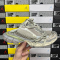 Light gray Balenciaga sneaker with mesh texture and sage green trim, lace-up.