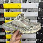 Light gray Balenciaga sneaker with mesh texture and sage green trim, lace-up.