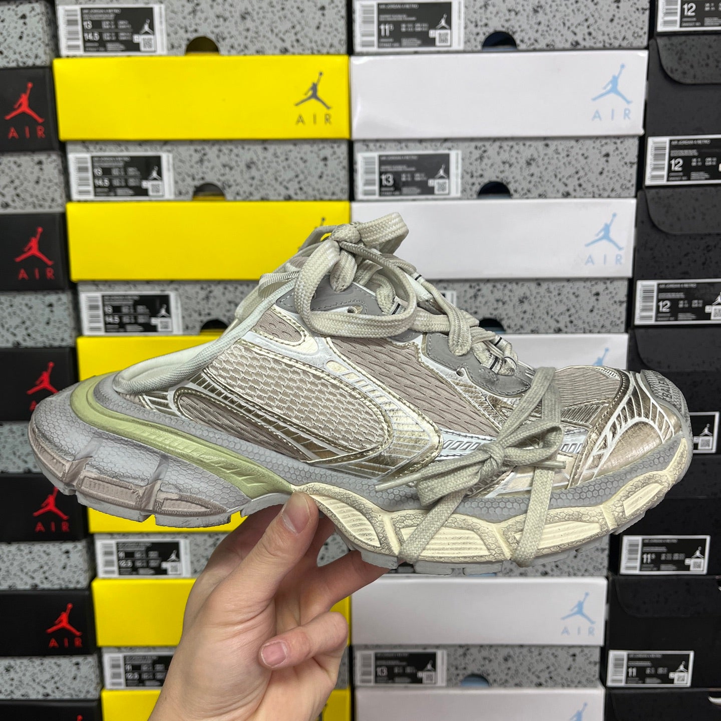 Light gray Balenciaga sneaker with mesh texture and sage green trim, lace-up.