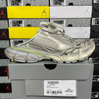 Light gray lace-up sneaker with textured paneling and sage green side stripe.