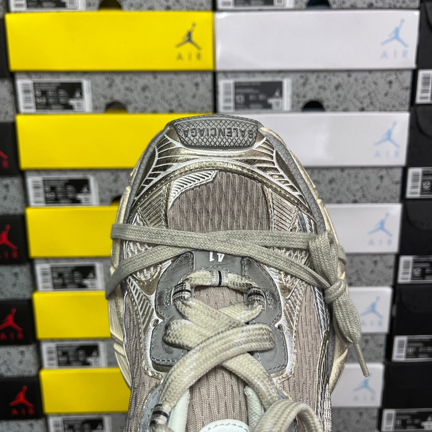 Light gray mesh sneaker upper with laces and stitched panel details.
