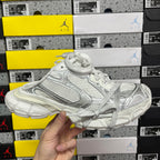 White Balenciaga lace-up sneaker with textured side panels and molded sole