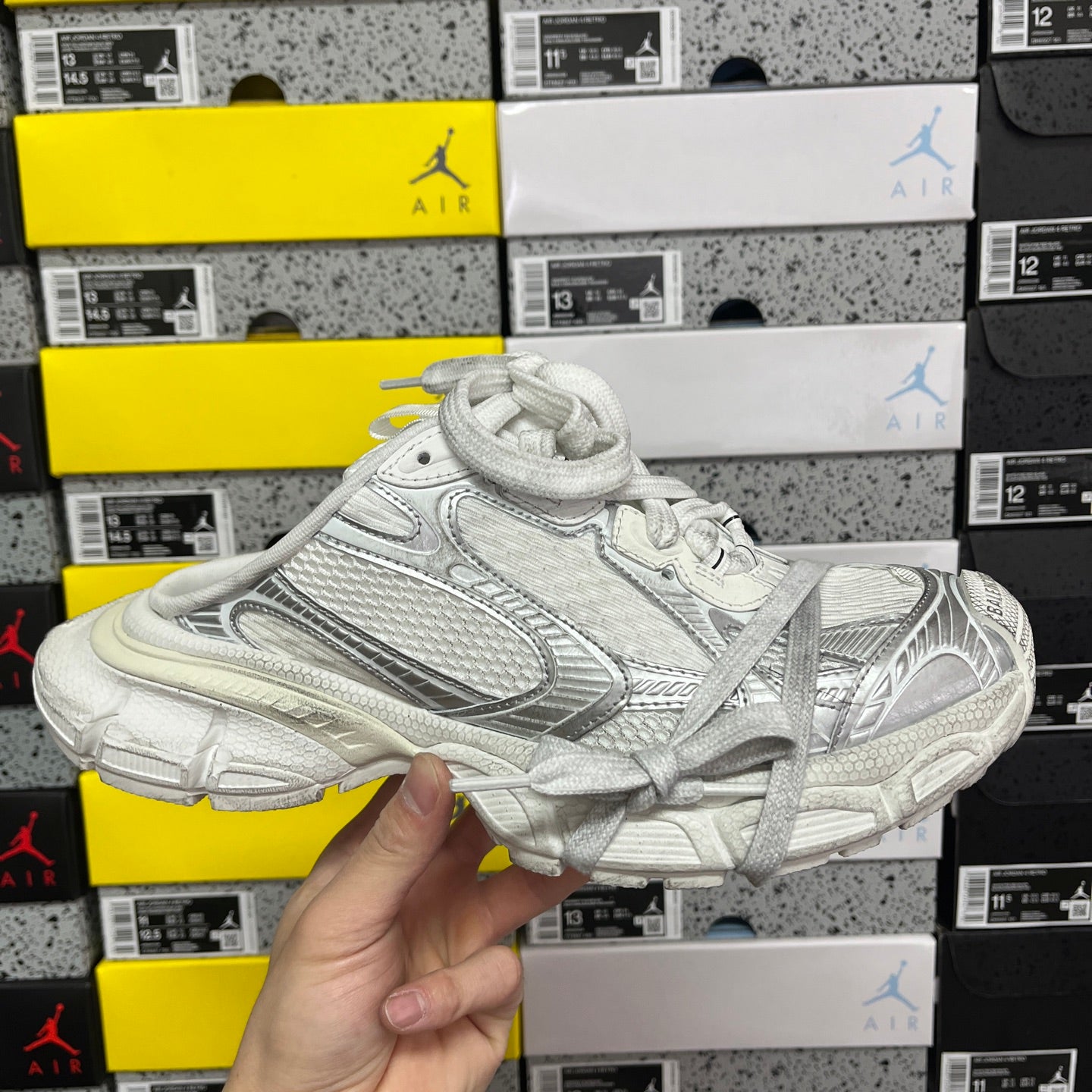 White Balenciaga lace-up sneaker with textured side panels and molded sole
