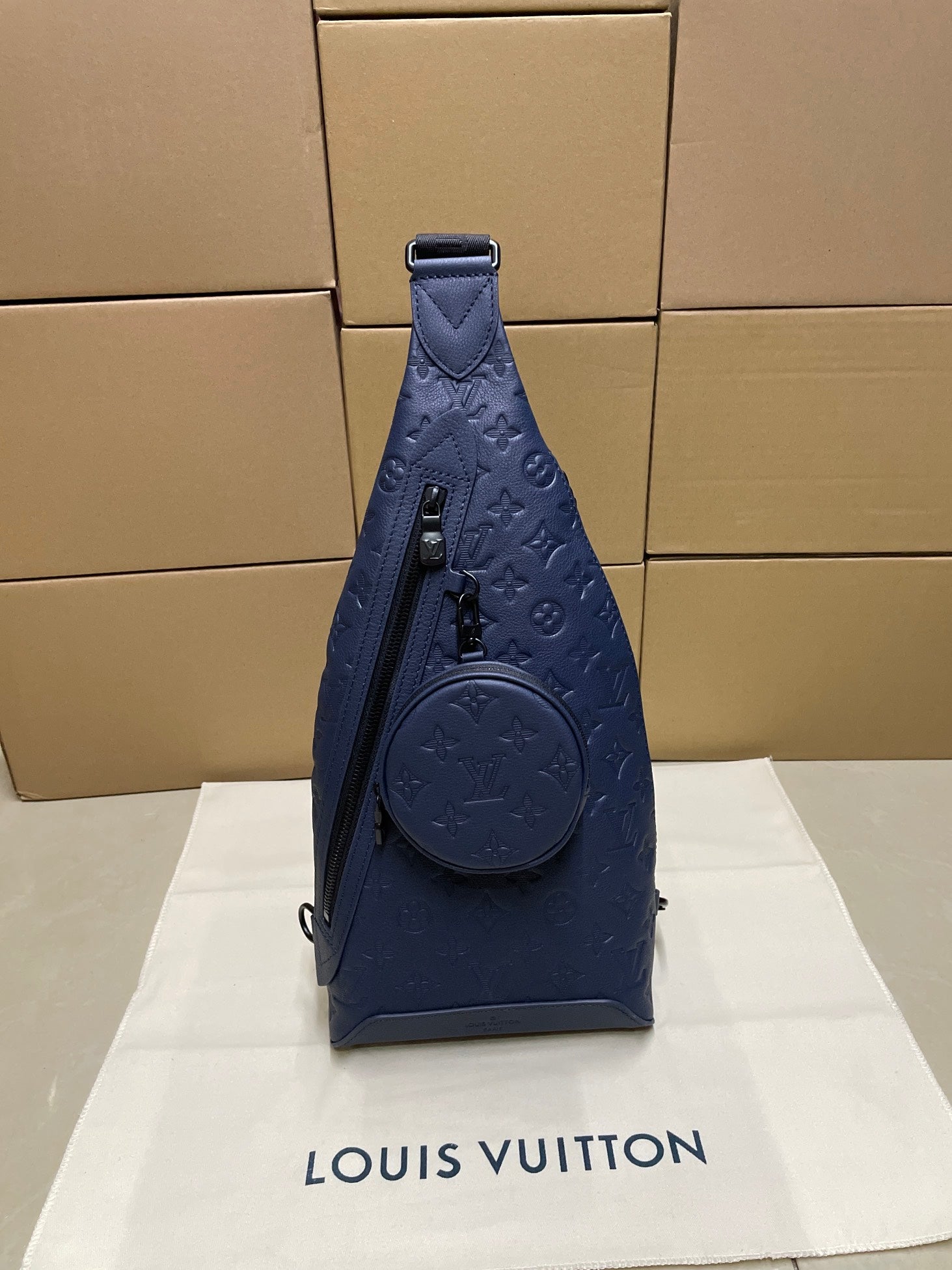 Louis Vuitton monogram sling bag in dark blue with top handle and front round pouch