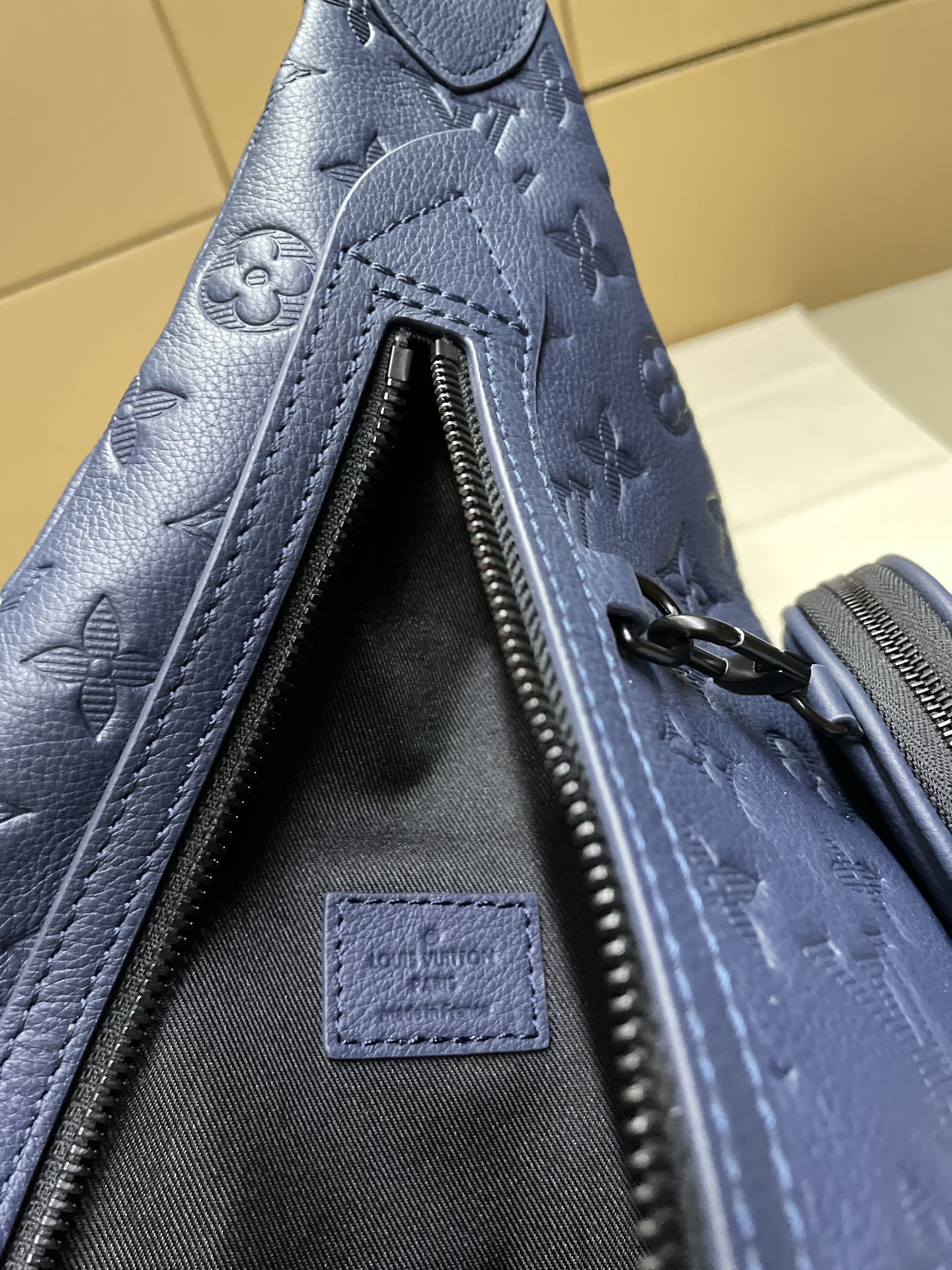 Blue monogram bag interior with zip track and fabric lining panel
