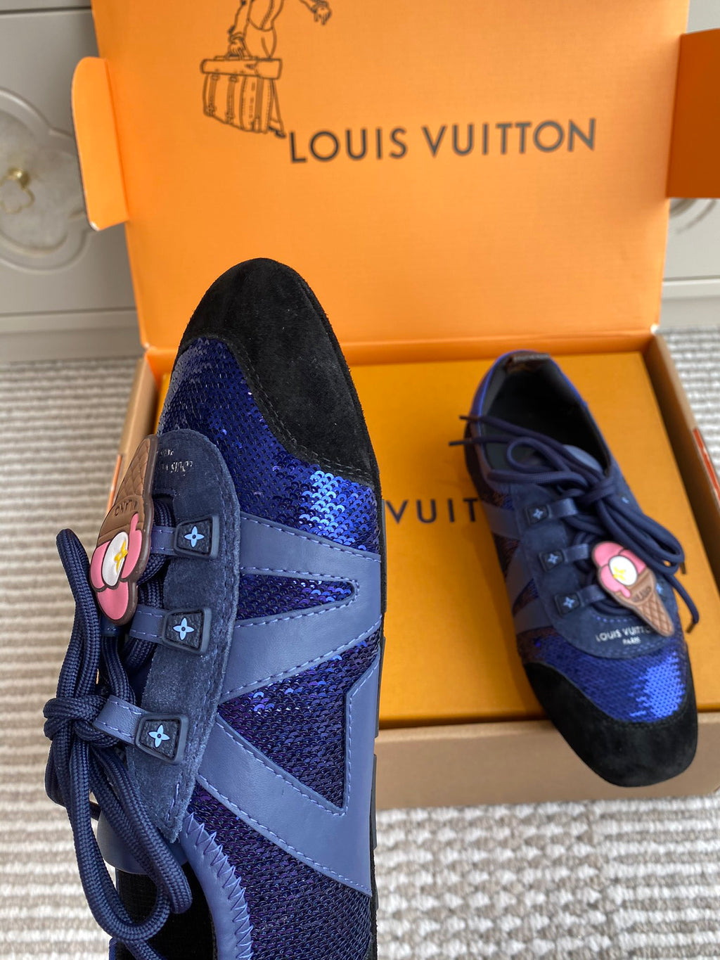 Louis Vuitton unisex sneakers, close-up of blue lace-up vamp and black side panels