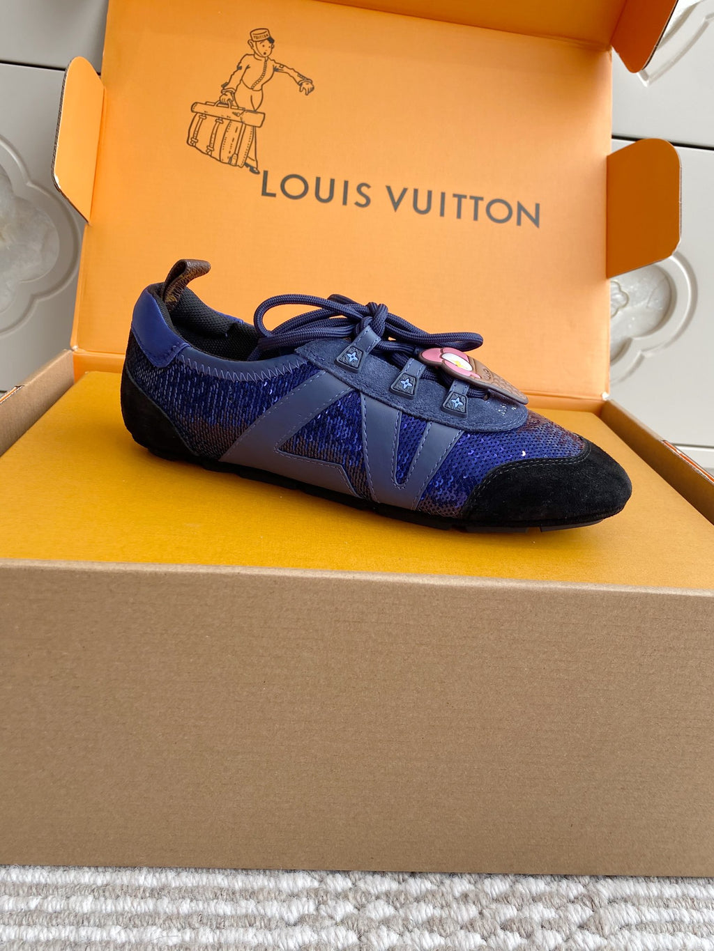 Louis Vuitton unisex sneakers, side view with blue textured uppers and black trim