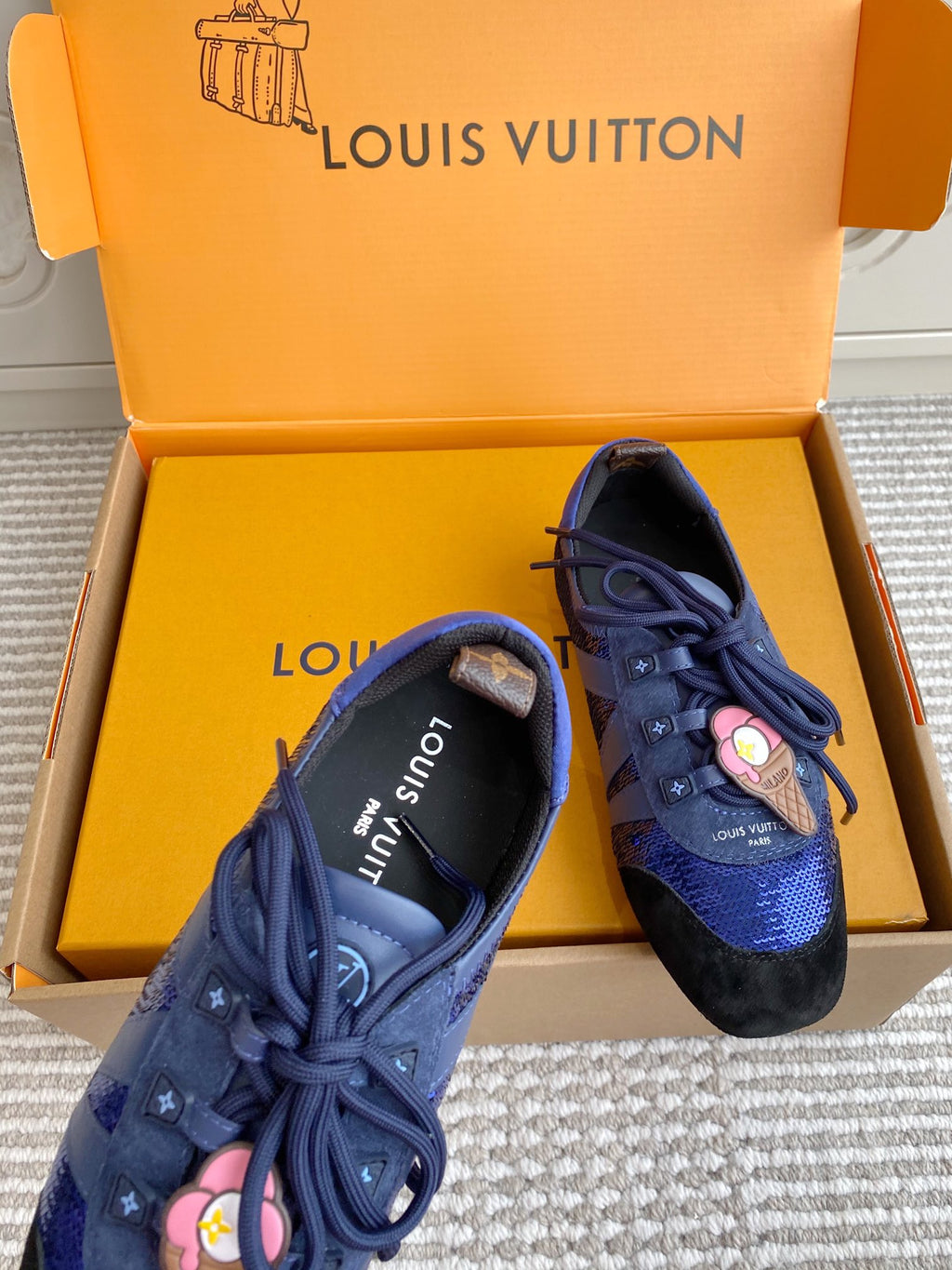 Louis Vuitton unisex sneakers, angled pair with blue lace-up front and black heel
