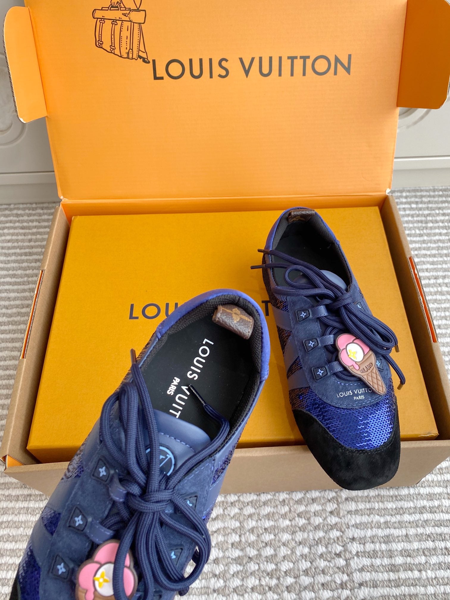 Louis Vuitton unisex sneakers, angled pair with blue lace-up front and black heel