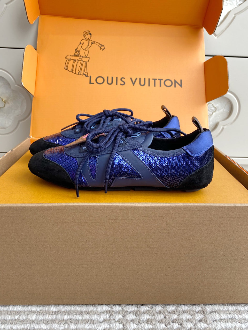 Louis Vuitton unisex sneakers on shoebox, blue upper with black sole, lace-up
