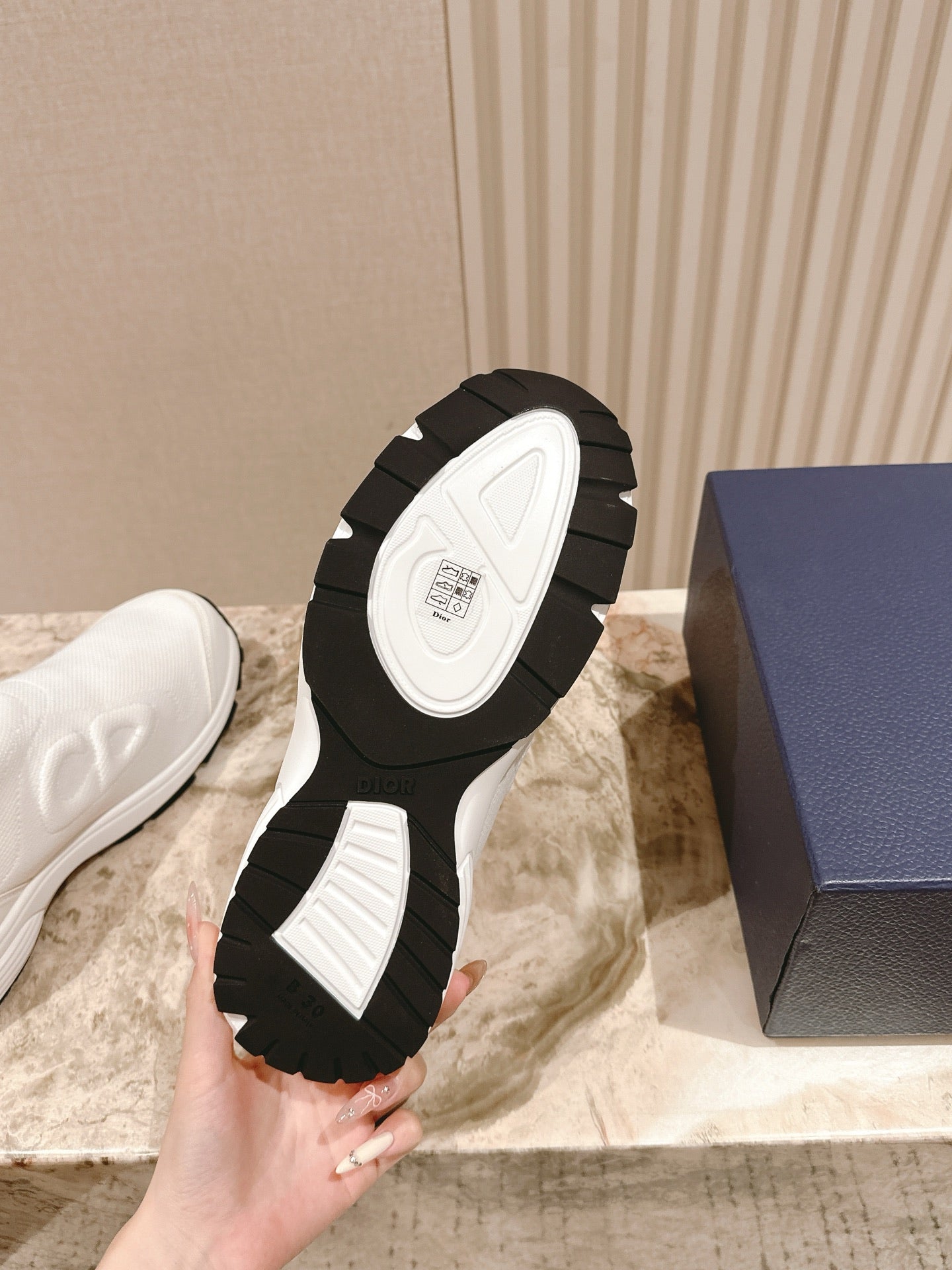 White slip-on sneaker outsole close-up with black rubber tread pattern