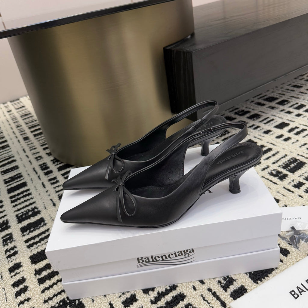 Black pointed-toe slingback heels with bow ties and stiletto heel